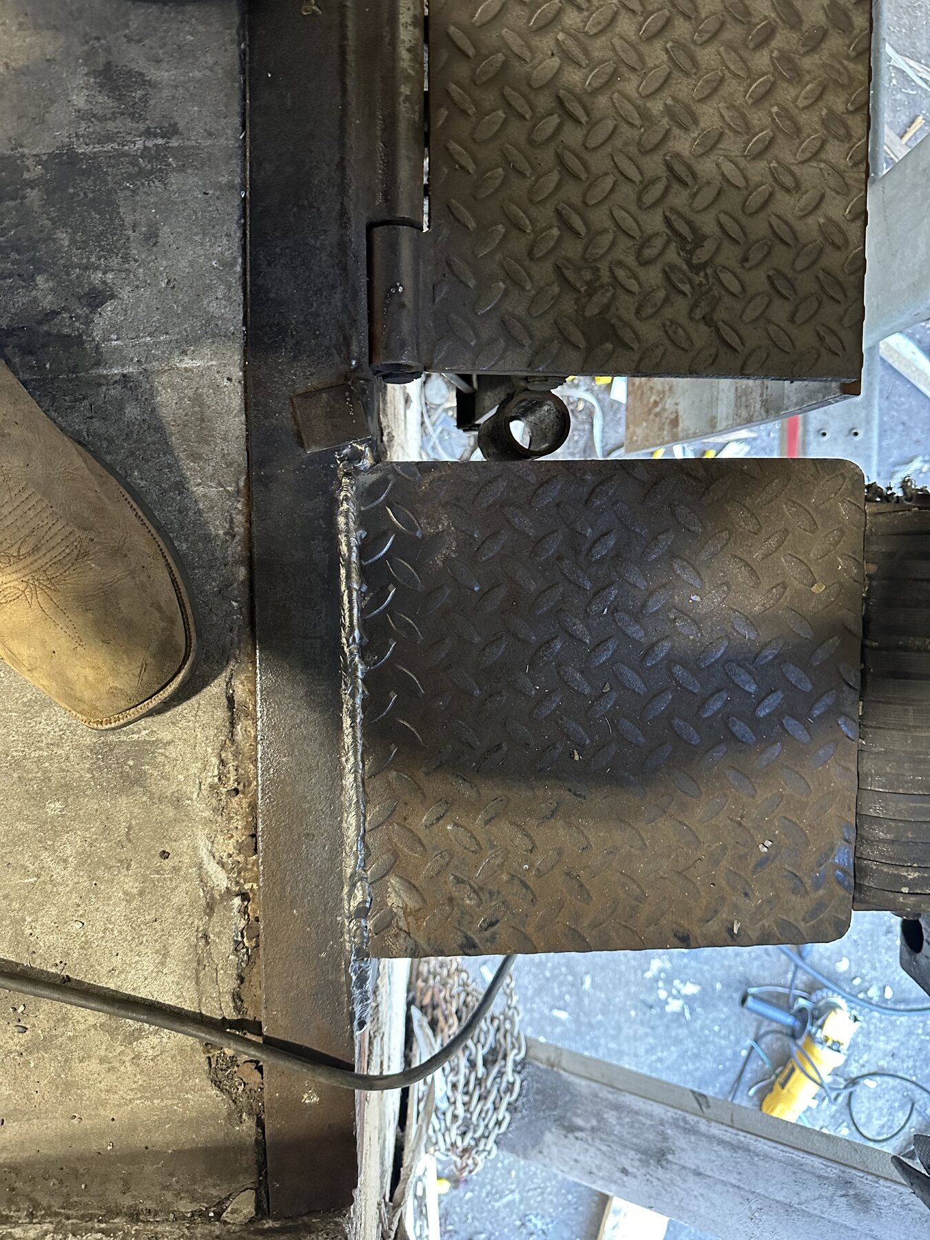 Completed mobile weld repair on loading dock hinge connection