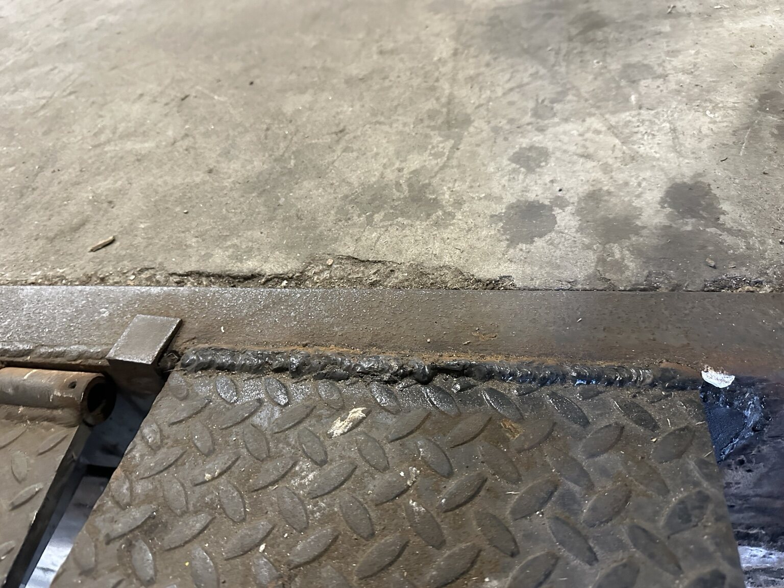 Commercial loading dock plate before welding repair in Gadsden