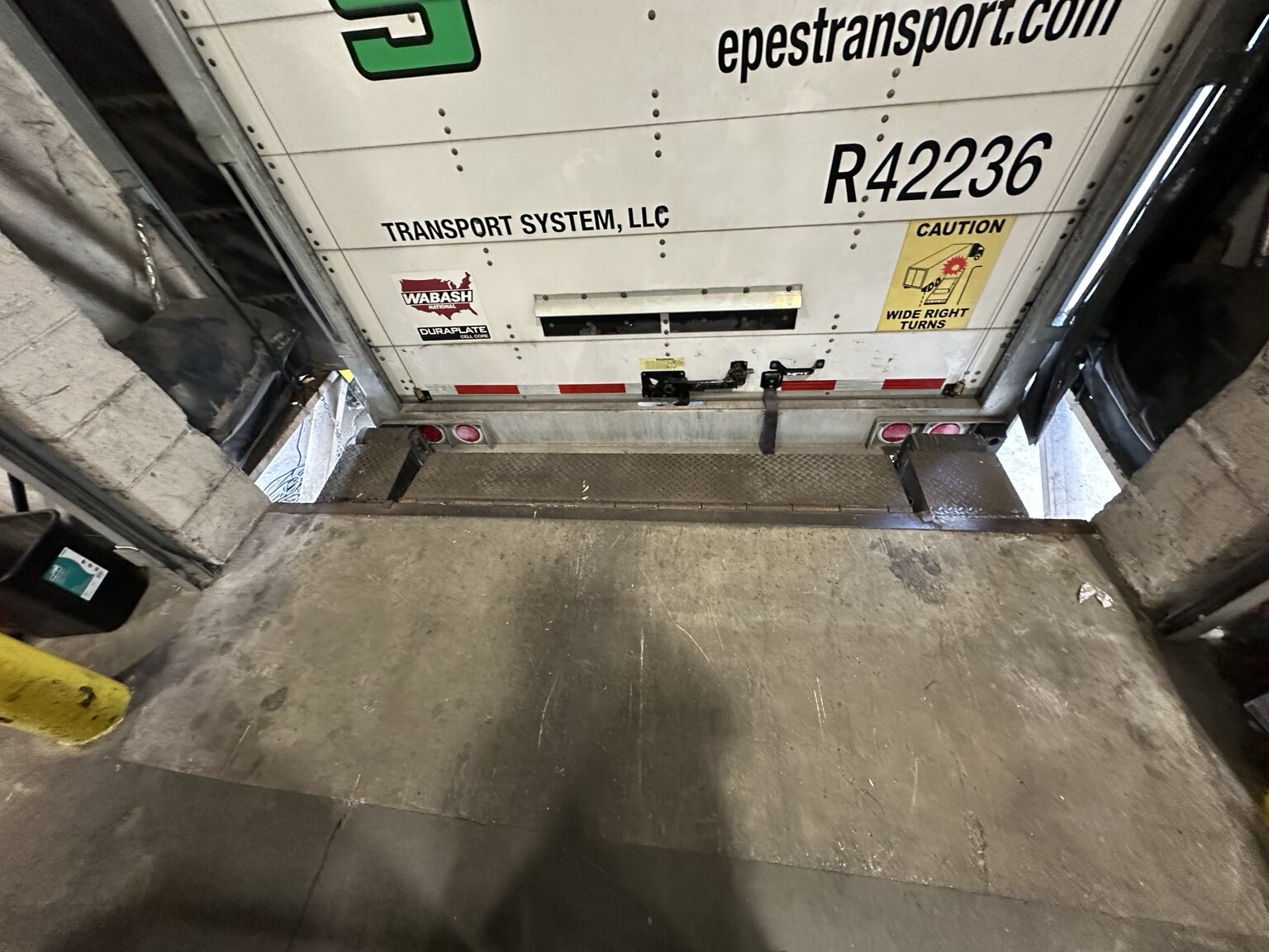 Truck trailer positioned at the repaired Lowe's commercial loading dock