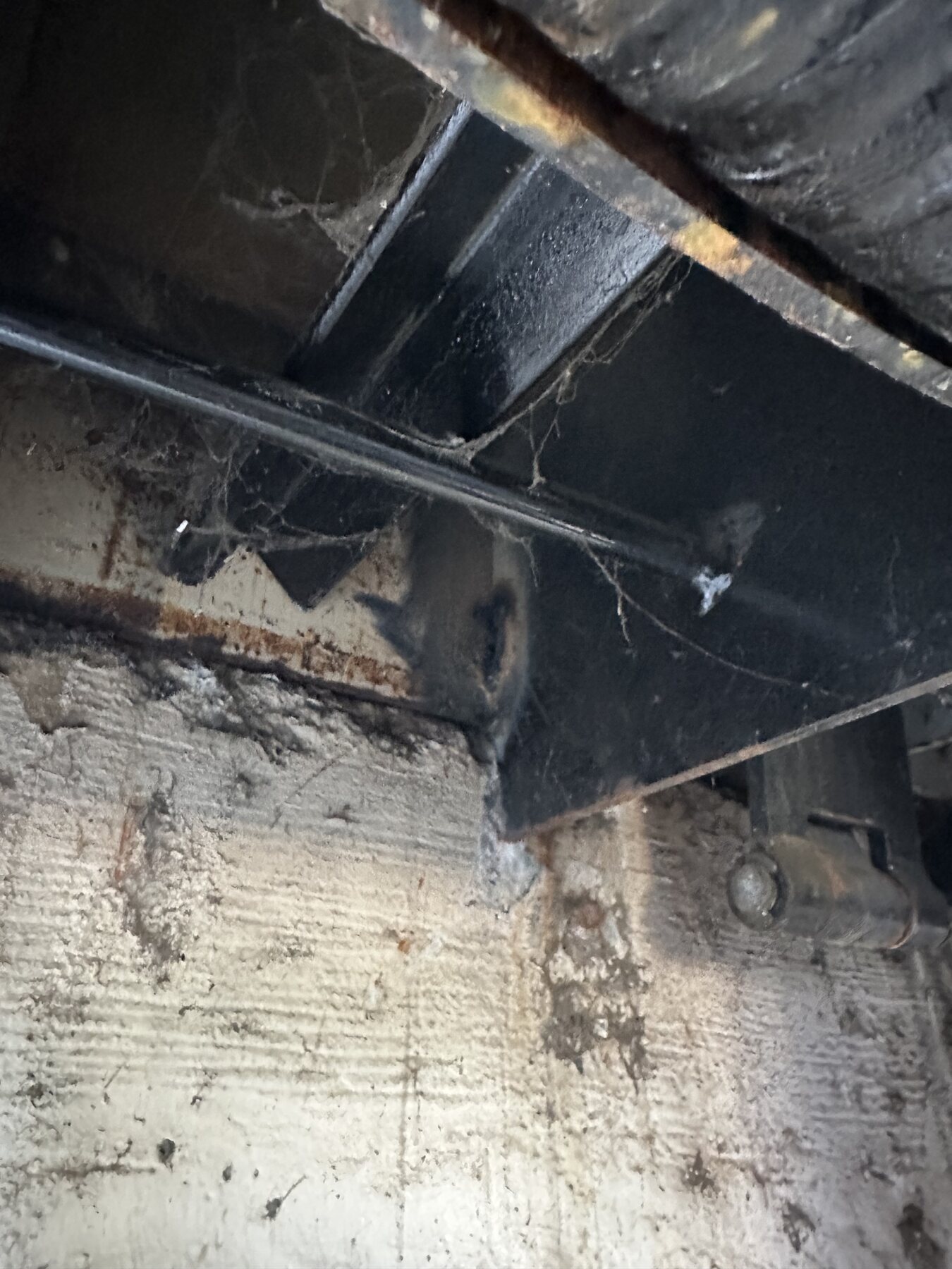 Repaired steel connection beneath a commercial loading dock plate