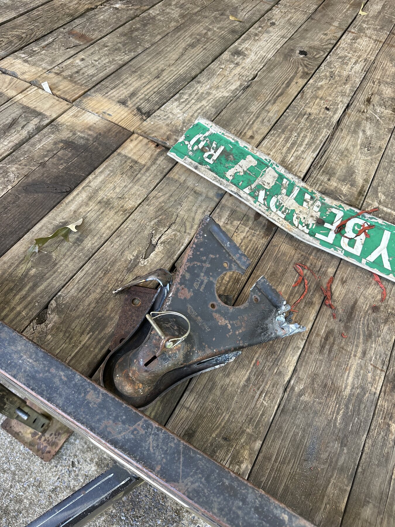 Old damaged trailer hitch piece after being cut off in Anniston Alabama